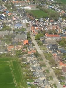 an aerial view of a town with houses and a street at De Hoffstee in Minnertsga