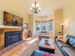 a living room with a fireplace and a tv at Federation House on Genesta St Central Cowes in Cowes