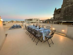 a table and chairs on the balcony of a building at Monte Bello Suites in Montescaglioso