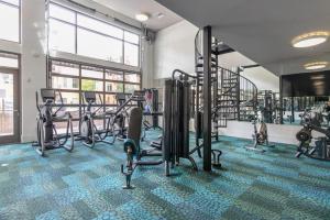 a gym with cardio equipment and tread machines at Blueground Mountain View pool nr Shoreline Park SFO-1928 in Castro City