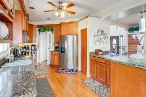 a kitchen with wooden cabinets and a stainless steel refrigerator at Take Metro to DC! Family Home in Springfield in Franconia