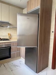 a stainless steel refrigerator in a kitchen at roeya résidence in Nador