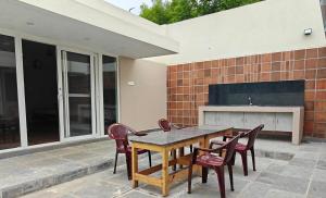 a table and chairs sitting on a patio at Maple Dreams Retreat- A Pool side Villa in Pondicherry