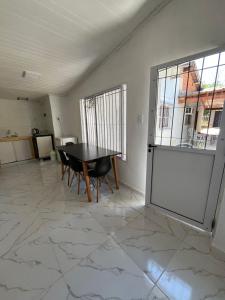 a dining room with a table and chairs and a window at alojamiento lolita in Puerto Iguazú