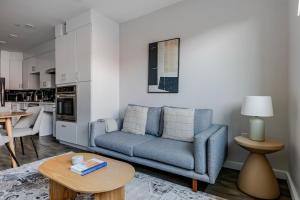 a living room with a blue couch and a table at Blueground Central Square rooftop nr Harvard BOS-1258 in Cambridge