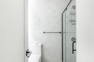 a bathroom with a toilet and a glass shower at Blueground Southside view nr Brooklyn Bridge NYC-2082 in Brooklyn +12 photos