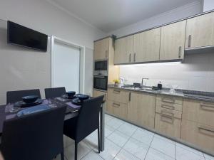 a kitchen with a table and chairs in a room at Ocean View in Santa Cruz
