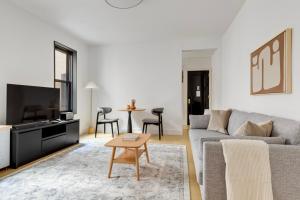 a living room with a couch and a table at Blueground Brooklyn Heights view nr Brooklyn Bridge NYC-1987 in Brooklyn