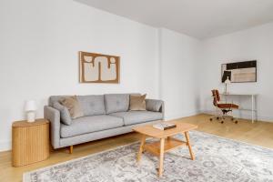 a living room with a couch and a table at Blueground Brooklyn Heights view nr Brooklyn Bridge NYC-1987 in Brooklyn