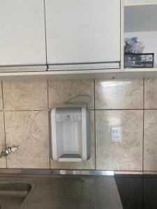 a paper towel dispenser on the wall of a kitchen at Studio Shine - Apartamento inteiro para COP in Belém +35 photos