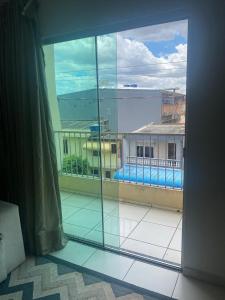 a view of a balcony with a view of a building at Studio Shine - Apartamento inteiro para COP in Belém
