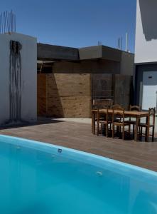a house with a swimming pool and a table and chairs at Villa Hotel in Bom Jesus da Lapa