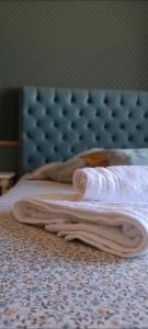 a pair of towels sitting on top of a bed at Allegoria House in Nafplio