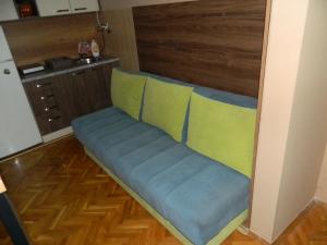 a couch sitting in the middle of a kitchen at Alesandro in Jagodina