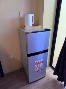 a small refrigerator with a bucket on top of it at Carolina Siargao Homestay in General Luna +5 photos
