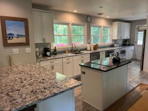a large kitchen with white cabinets and granite counter tops at Broad hollow 5 in Rehoboth Beach