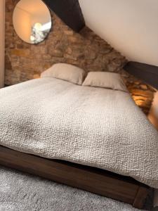 a bedroom with a large bed with a mirror at La Casa De Campo in Long Preston