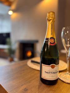 a bottle of champagne sitting on a wooden table at La Casa De Campo in Long Preston +23 photos