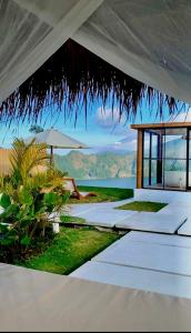 a white pavilion with a view of the ocean at The Dream Hill Bali - Kintamani in Kubupenlokan