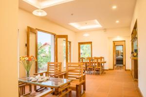 a dining room with a table and chairs at The Garden House Phu Quoc Resort in Phu Quoc