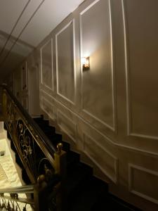a stairway with a light on the wall and a door at Eighth Wonders Hotel in Wadi Musa