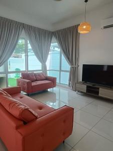 a living room with a couch and a flat screen tv at 4 Storey House 14Pax 4Bedroom 9 Bukit Jambul in Bayan Lepas