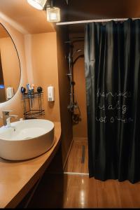 a bathroom with a sink and a shower at Villa ZeN- with Private garden and beach in Samos