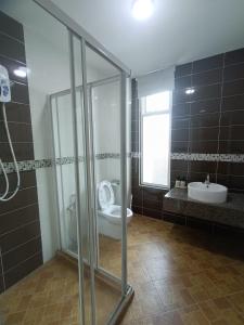 a bathroom with a shower and a toilet and a sink at 4 Storey House 14Pax 4Bedroom 9 Bukit Jambul in Bayan Lepas