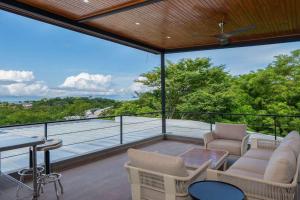 a balcony with a view of the ocean at Beach Mode Luxury 3-Story House in Tamarindo in Tamarindo