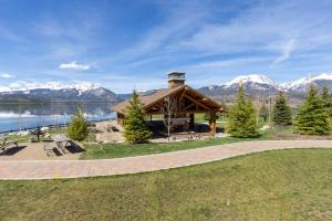 a gazebo with a lake and snow covered mountains at Lake Cliffe #305 Building A in Dillon