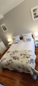 a bedroom with a bed with a blanket on it at Zacisze by the Park in Szczawno-Zdrój