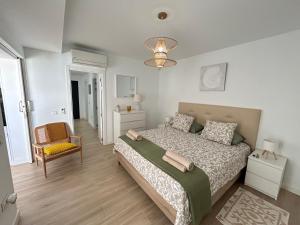 a bedroom with a bed and a chair at Mariposa Blanca in Villaverde +39 photos