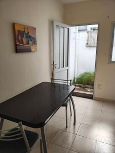 a dining room with a table and a window at Departamento Peña in Carhué