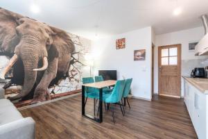 a dining room with an elephant mural on the wall at Zakątki Świata in Poznań