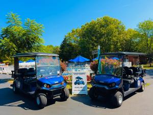 two golf carts are parked next to a sign at Put-in-Bay Island Club #66 in Put-in-Bay