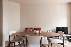 a dining room with a wooden table and chairs at Ruim, stijlvol gerenoveerd vakantieappartement voor 4 personen vlak bij zee en de duinen in De Panne