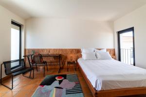 a bedroom with a bed and a tv and a table at Calipo in Vila Viçosa +54 photos