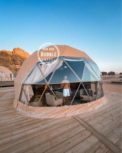 a person is standing inside of a tent at BUBBLES LUXURY CAMp & BUBBLES ROOM in Disah +58 photos