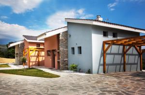 a house with a garage and a driveway at Ktima Papadopoulou in Krionérion