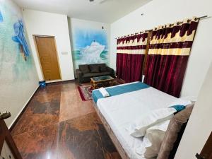 a bedroom with a bed and a couch in a room at LUXE Penthouse 4BHK with Swimming pool in Mysore +46 photos