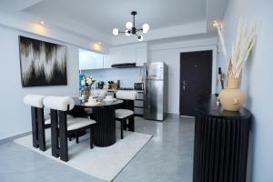a kitchen with a table and chairs and a refrigerator at Orchid Residency, Westlands in Nairobi
