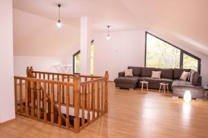 a living room with a couch and a table at Cabana Walter Curtea de Arges with BBQ and Garden in Curtea de Argeş