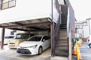 a white car is parked in a car garage at Ao by Perch Japan in Nagoya