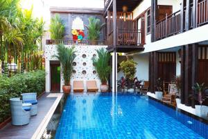 a swimming pool in the middle of a house at Viang Thapae Resort- SHA Extra Plus in Chiang Mai