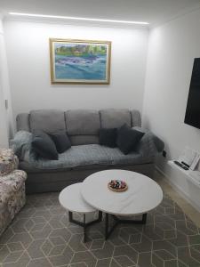 a living room with a couch and a coffee table at Green Home Bihać in Bihać