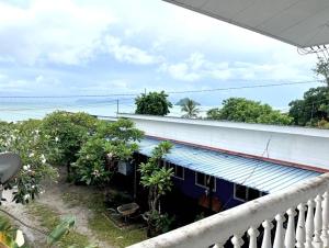 a balcony view of a house with the ocean in the background at BlackSands Guests House Langkawi in Huma