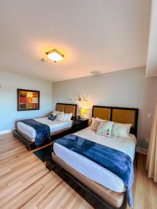 two beds sitting in a room with at Fairway To Heaven At Four Season 2bed2bath Condo in Lake Ozark +52 photos