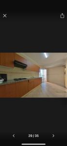 a kitchen with wooden cabinets and a counter top at Tanja Pearl in Tangier