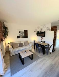 a living room with a couch and a table at cosystudio Superdevoluy 5pers pied des pistes in Le Dévoluy