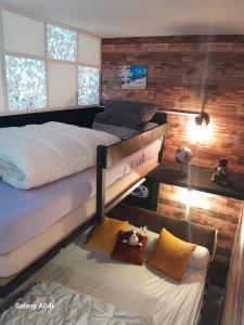 a bedroom with two bunk beds and a table at cosystudio Superdevoluy 5pers pied des pistes in Le Dévoluy